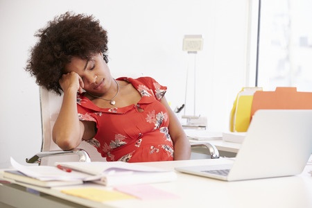 Woman sleeping at office desk