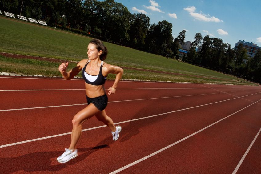 athlete running on track
