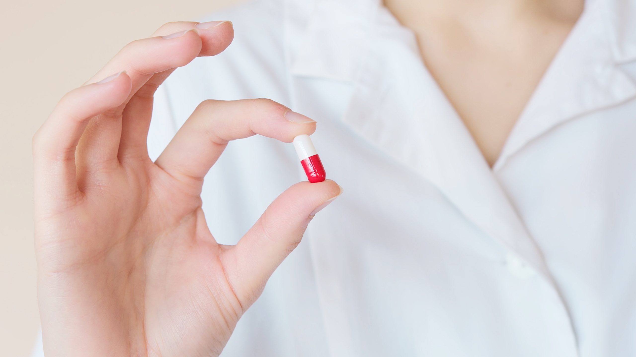 woman holding prescription pill