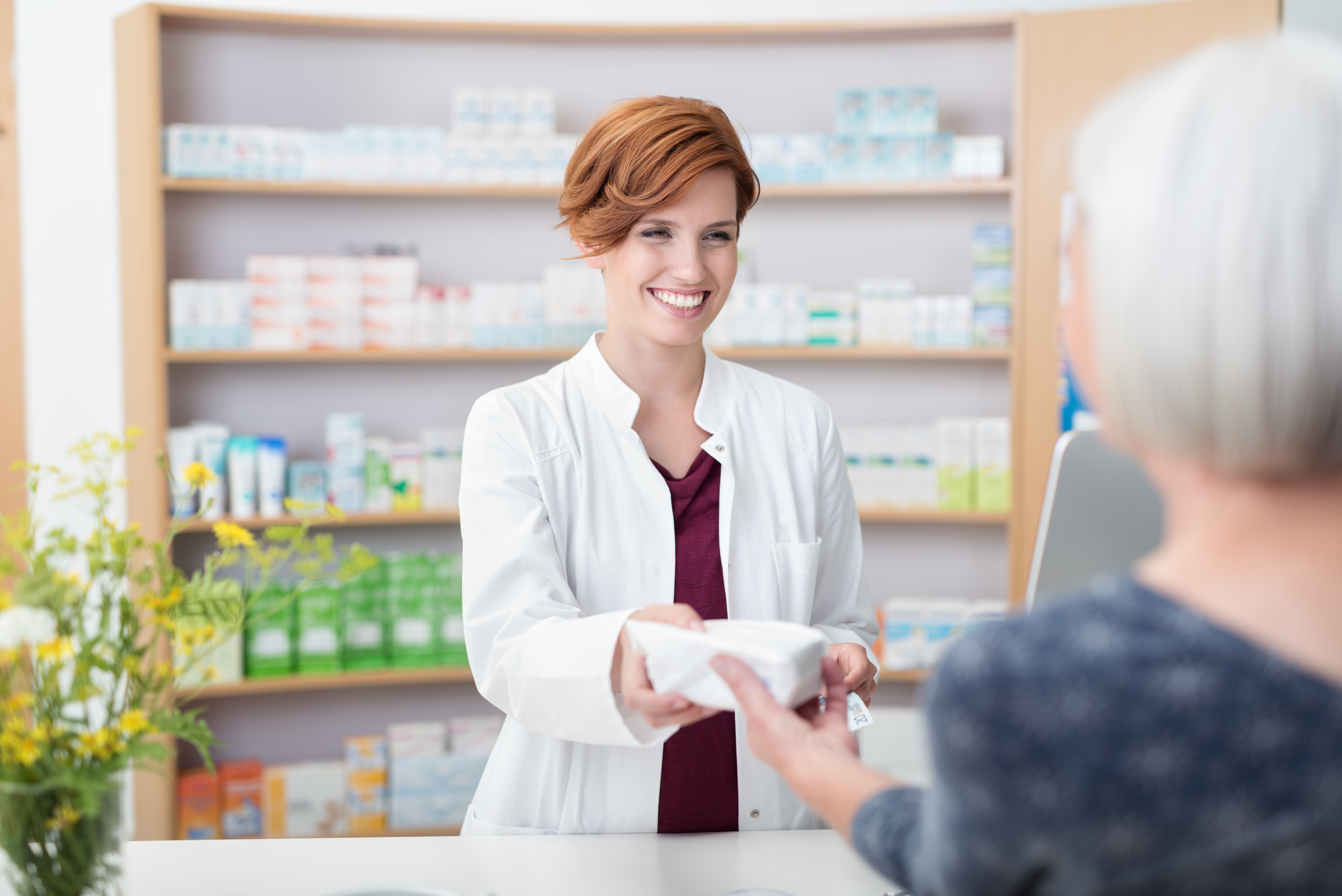 pharmicist handing prescription to patient explaining how long does king soopers hold prescriptions