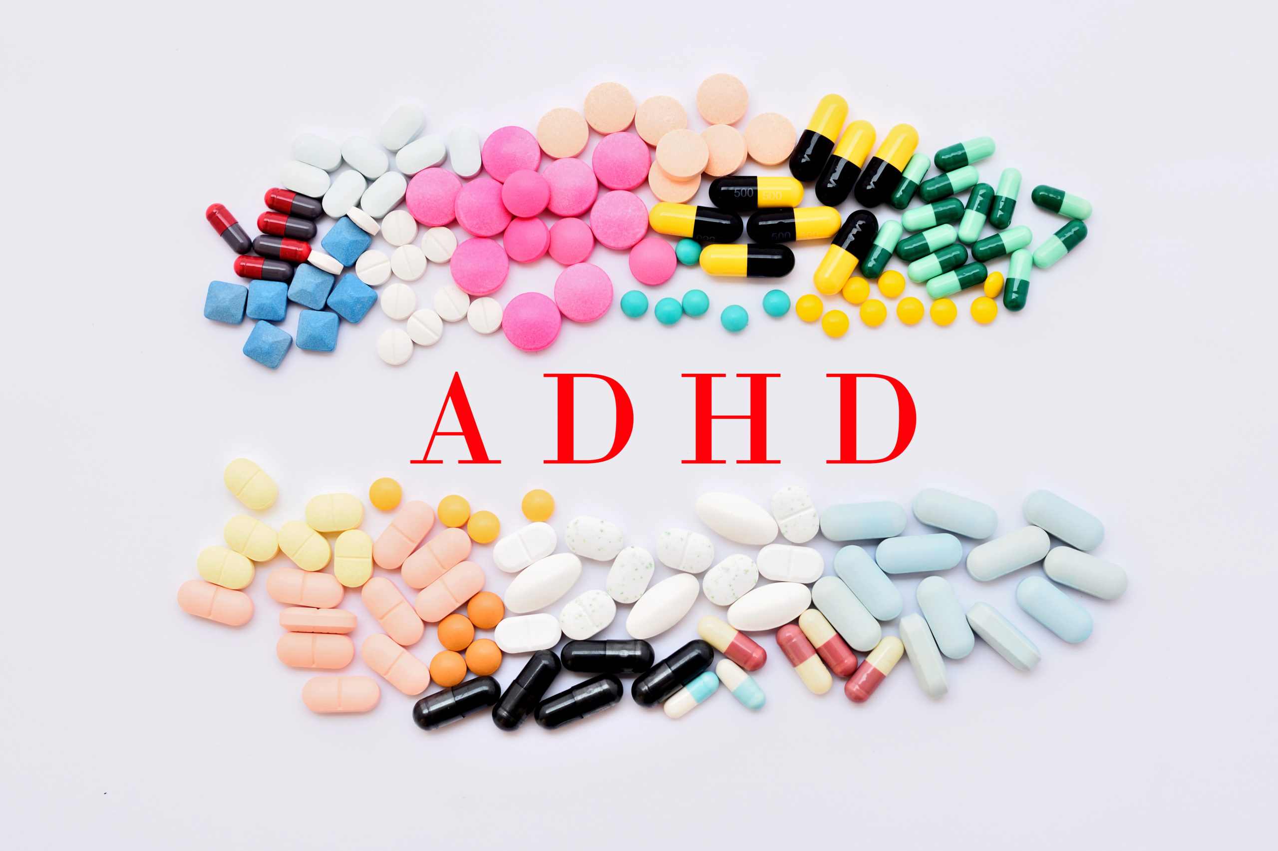 adhd medication comparison with the word ADHD in the center of pills